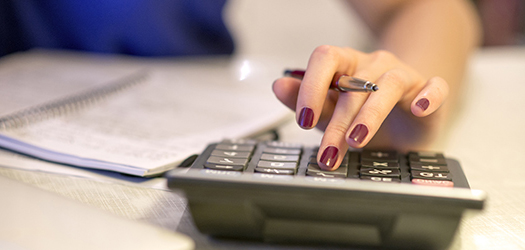 Close up of female accountant or banker making calculations