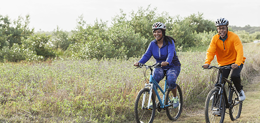 Mature African American couple riding bikes