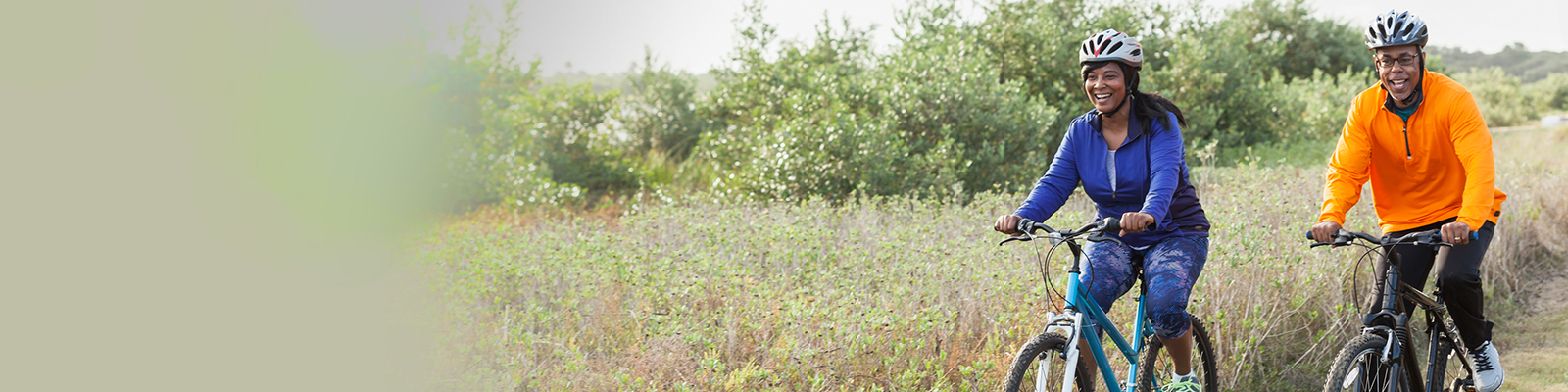 Mature African American couple riding bikes