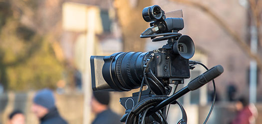 Video camera set up on a street for filming.